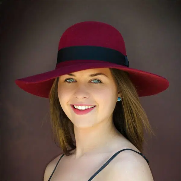 A young women wearing the wool zoe hat, she is wearing the red hat