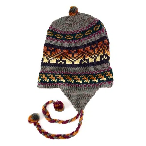 A grey hat made from yarn, with long earflaps