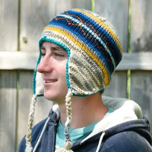 young man wearing the adult lined earflap hat, showing that the hat cover the ears to keep them warm