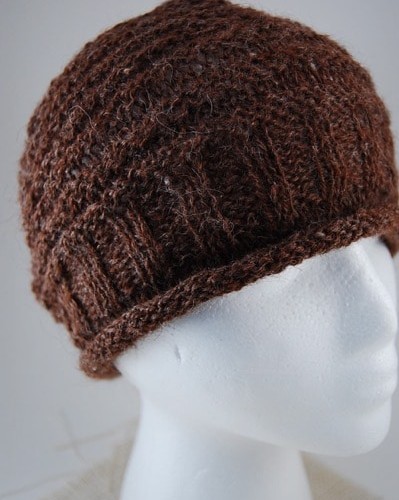 A close up of the rustic alpaca hat showing the patterns and rolled edges