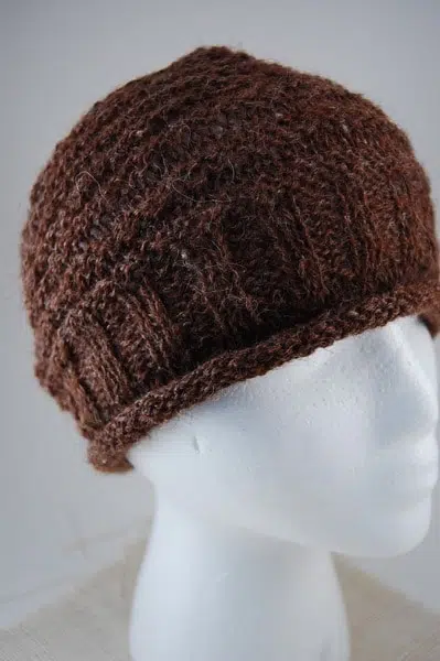 A close up of the rustic alpaca hat showing the patterns and rolled edges