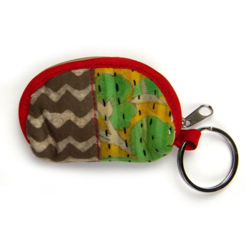 close up shot of cotton purse keychain showing the design and color, the color is red, brown, yellow, and green