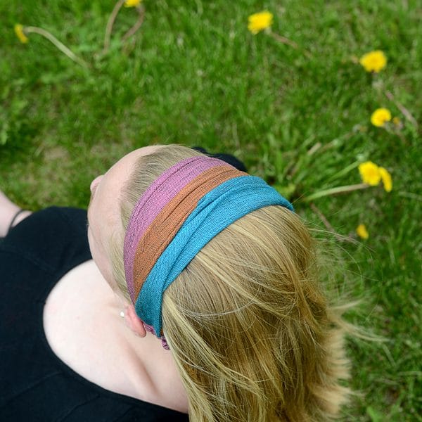 Young women wearing brightly colored striped headband