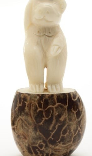 A monkey standing, this has been hand carved from a tagua seed.