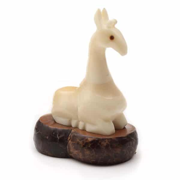 A sitting giraffe, hand carved and made from tagua.