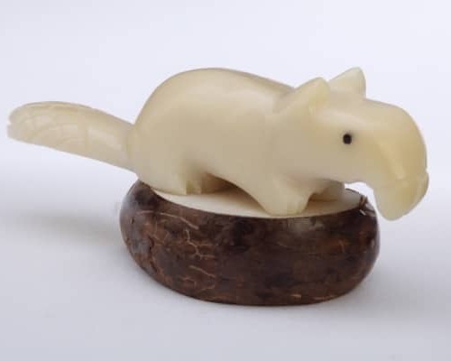 A beaver that has been carved with extreme detail in mind. these have been carved out of tagua nuts.