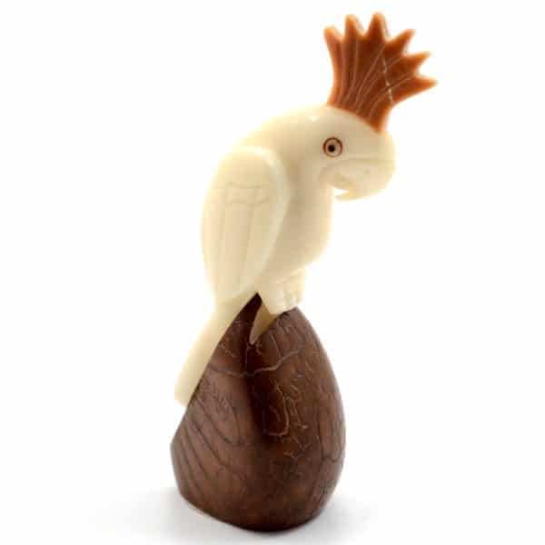 A carving of a cockatoo sitting on a tagua nut
