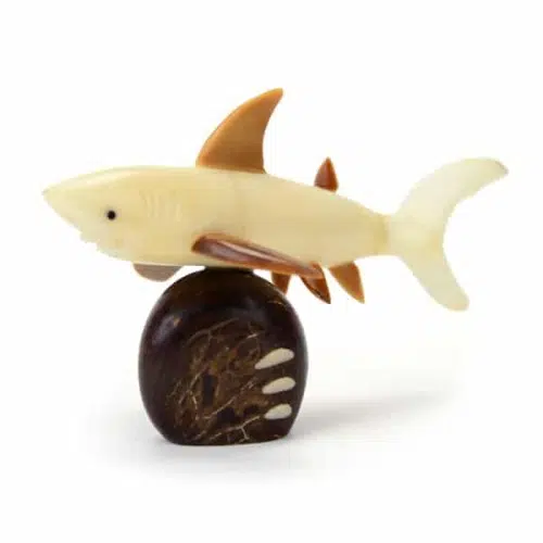 A shark swimming past a rock, made from tagua seeds.
