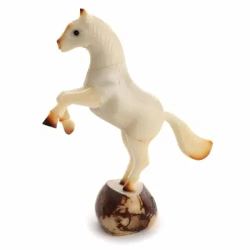 A horse made from a tagua nut, the house is standing on two legs