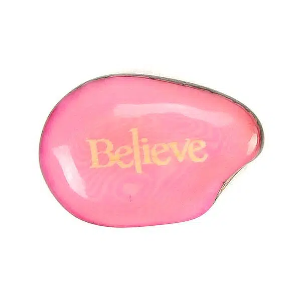 A tagua seed that says belive on it
