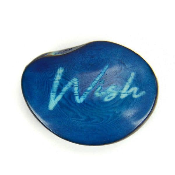 A tagua seed that says wish on it