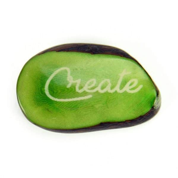 A tagua seed that says create on it