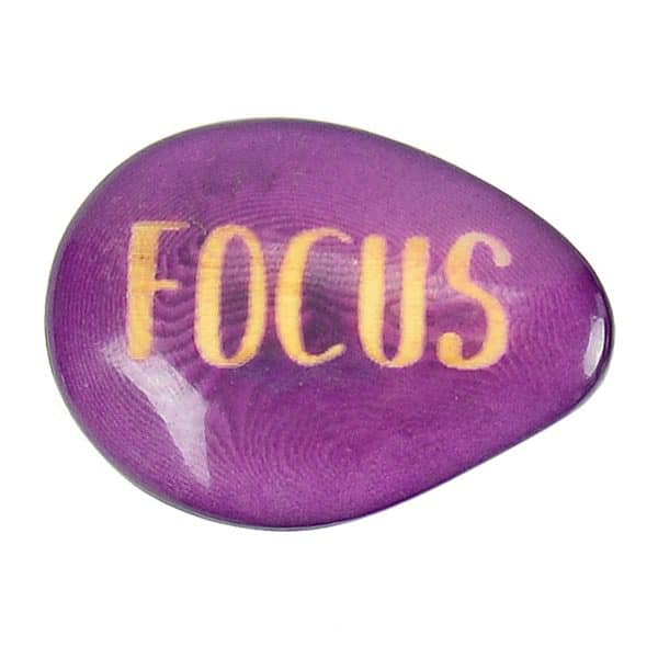 A tagua seed that says focus on it