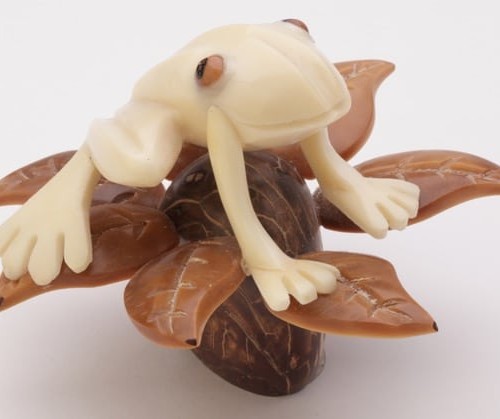 A frog sitting in a tree, these are hand carved and made from tagua nuts.