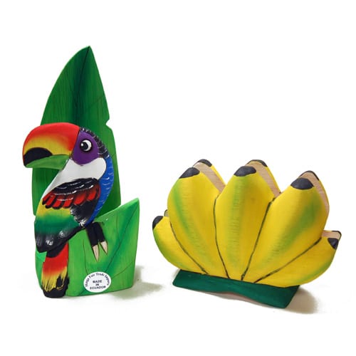 A hand carved napkin holder made to look like different things, the two in this picture are the tucan and the bananas