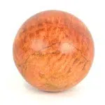A highly polished orange jasper carved sphere