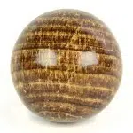 A highly polished aragonite carved sphere