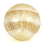 A highly polished, caramel, carved sphere.