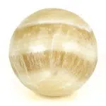 A highly polished, caramel, carved sphere.