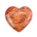 A highly polished orange jasper carved heart