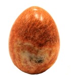 A highly polished orange jasper carved egg