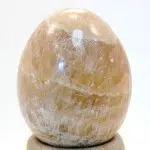 A highly polished, caramel, carved egg.