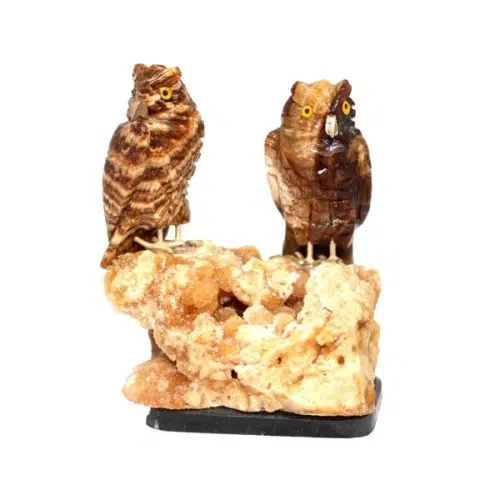Semi-Precious Stone Owl Pair sitting on some orange stone.