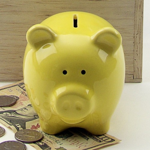 A small piggy bank that comes in different colors, this one is yellow.