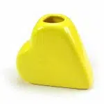 A small yellow heart vase great for holding things