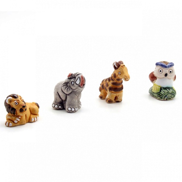 Four of the wild ceramic mini critters, those are lion, elephant, giraffe, and beaver.