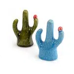 A blue and a green ring holder that looks like cactus