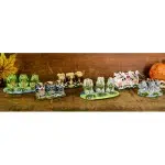 A picture of all of the different ceramic trio those are, frogs, owls, monkeys, turtles, cows, and elephants.