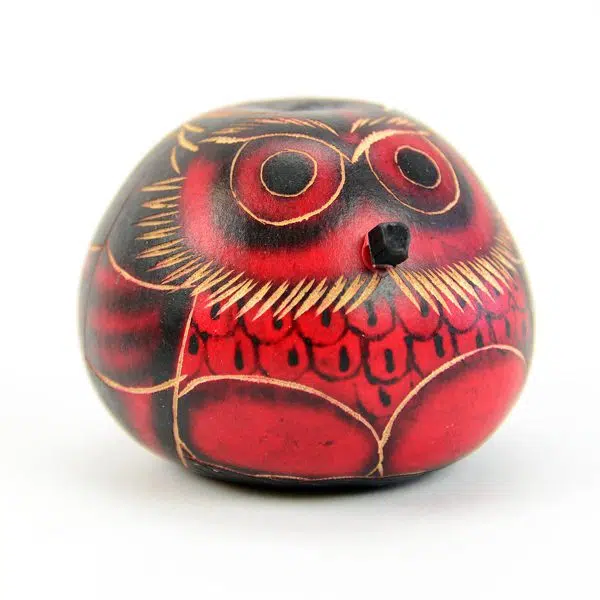 A close up of the red gourd owl ornament.