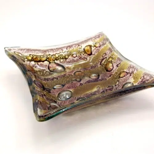 A fused glass dish that comes in a verity of colors and designs