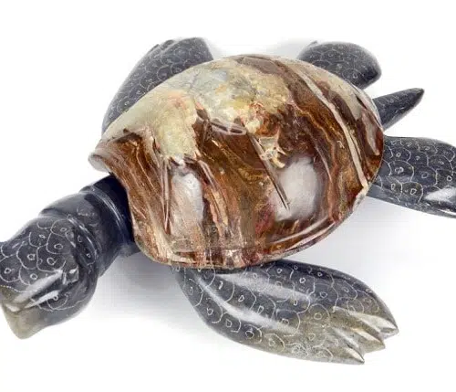 A large marble/onyx turtle, has a dark brown shell with with some dark blue legs and arms