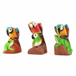 A hand carved statue of parrots with animals, these are carved out of balsa