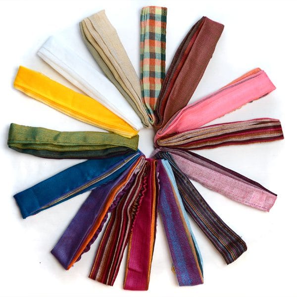 Bunch of different styles of brightly colored headbands on a white backdrop