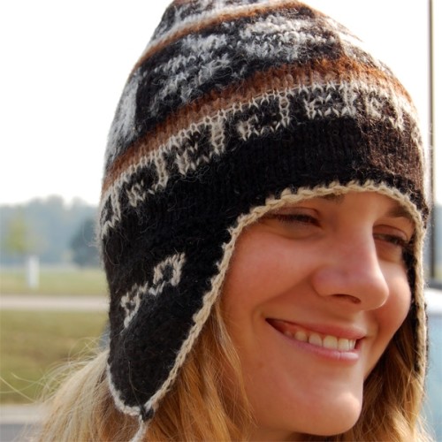 A young women wearing the rustic earflap hat