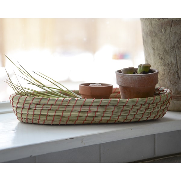 this hand coiled basket can hold silverware to pens