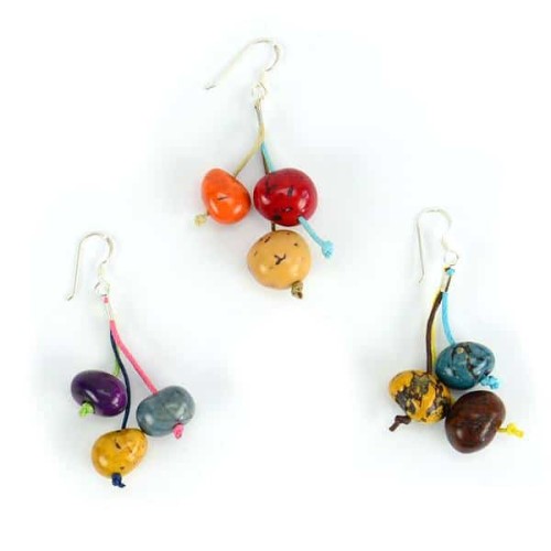 A picture of the fiesta earrings, earrings that come in bright colors with three tagua seeds attached to the earring.
