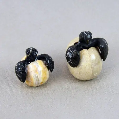 A close up of two turtles in eggs, these were made from marble and were carved