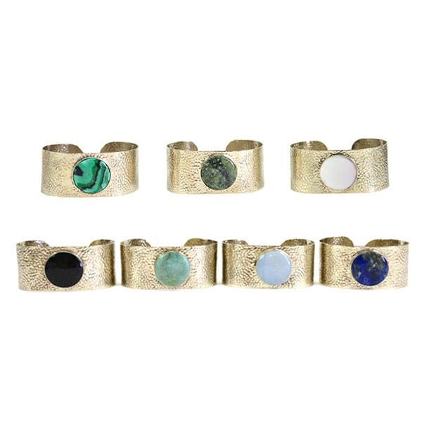 a bunch of different colored stones in the middle of the stone cuff, the colors are, green, dark green, white, black, turquoise, sky blue, and blue