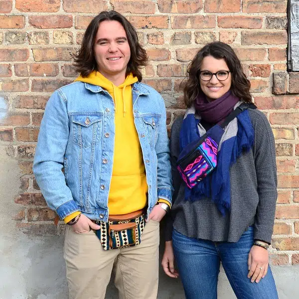 couple wearing a tan and a purple vegan leather fanny packs