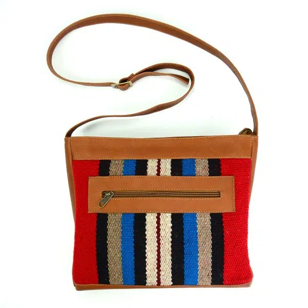 tan leather crossbody bag with double zipper in a striped pattern accent