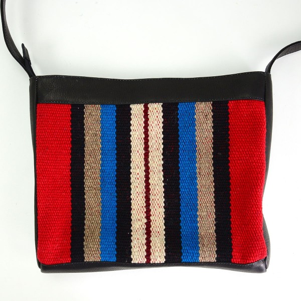 black leather crossbody bag with red, black, blue and tan striped pattern accent