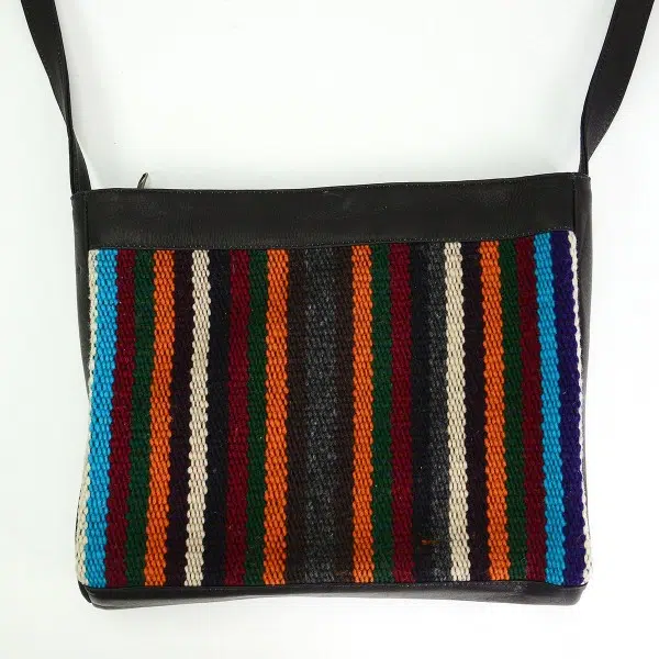 Black leather crossbody bag with earth tone striped pattern accent