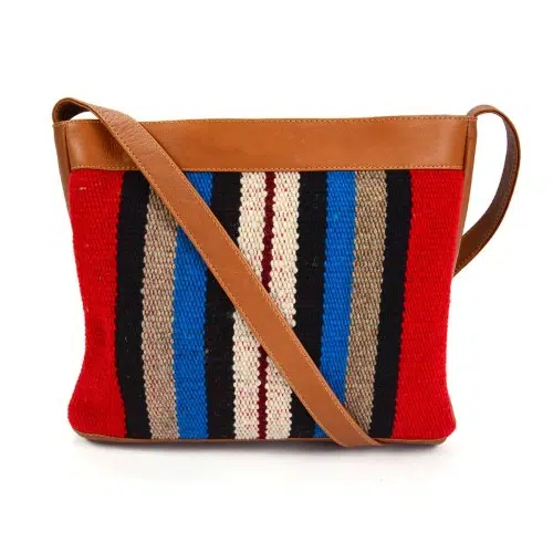 Tan leather crossbody bag red, black ,blue and beige striped pattern accent
