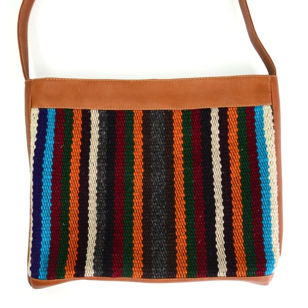 tan leather crossbody bag with earth tone striped pattern accent