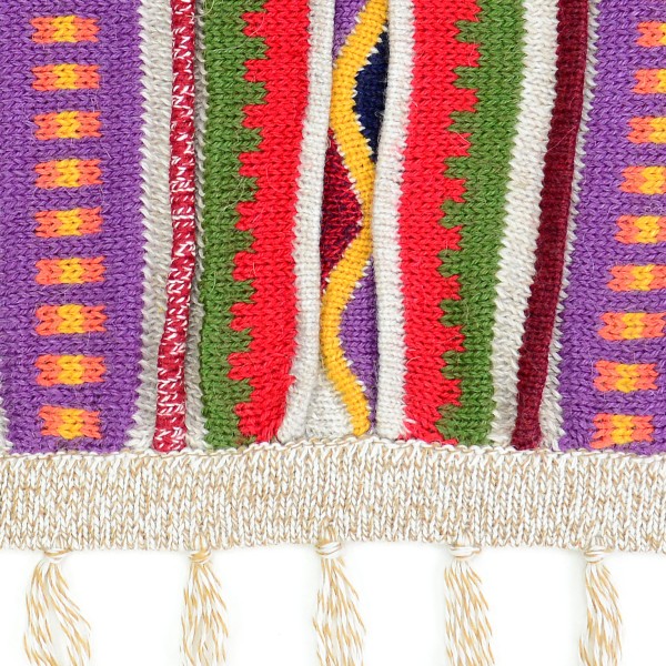 close up of the aurora alpaca poncho to show color and design, the color is white