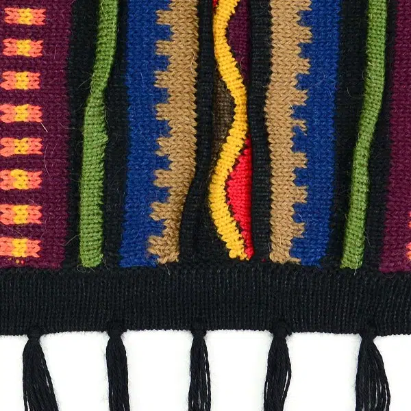 close up of the aurora alpaca poncho to show color and design, the color is black